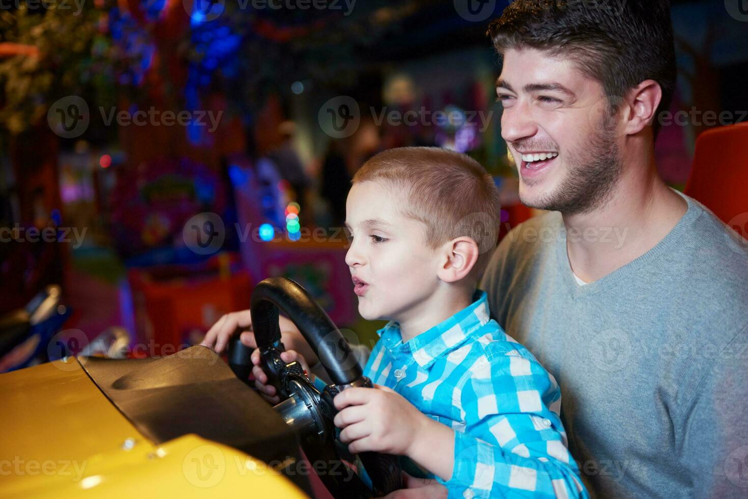 father and son playing game in playground photo