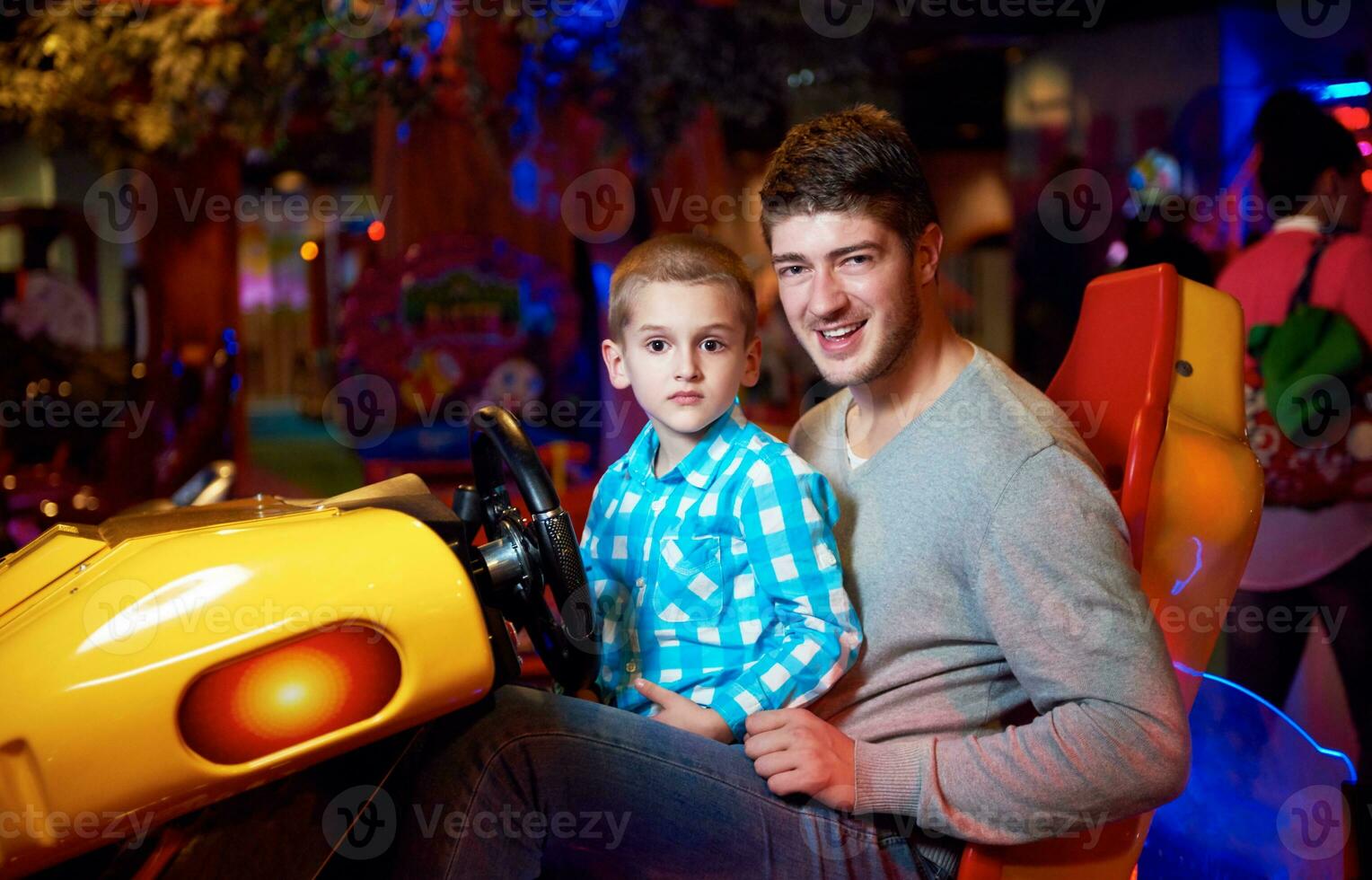 father and son playing game in playground photo