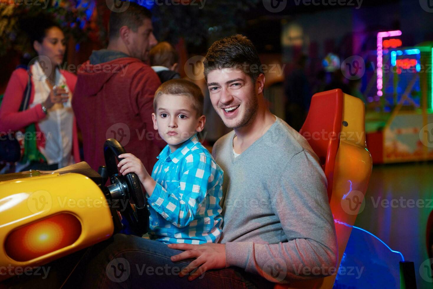 father and son playing game in playground photo