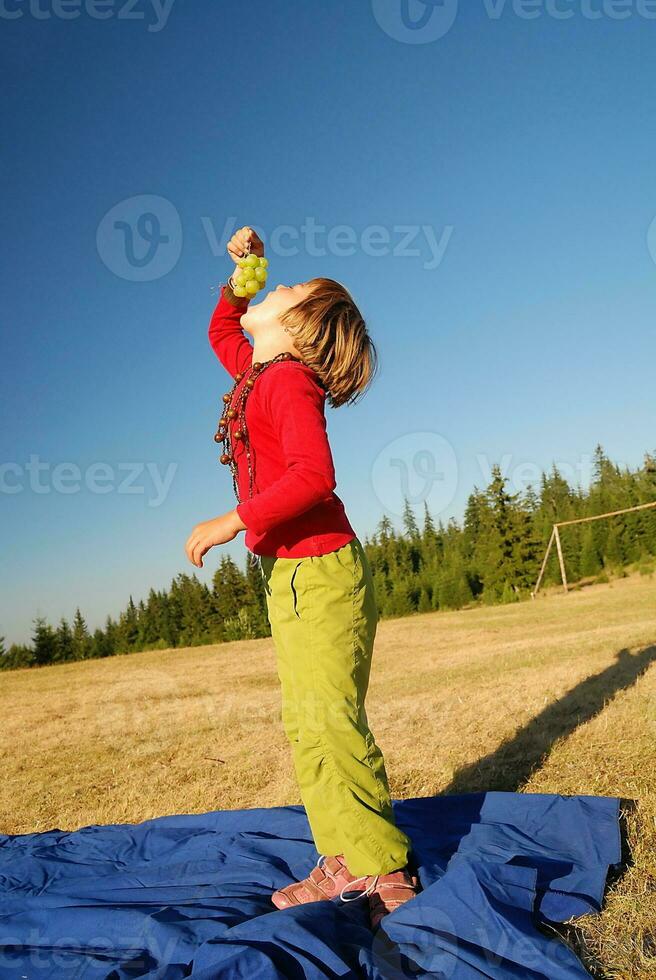 happy girl with grape outside photo