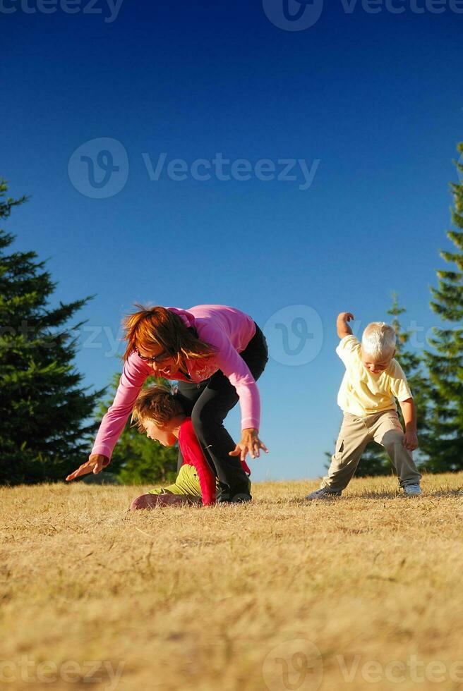 mother and kids having fun outside photo