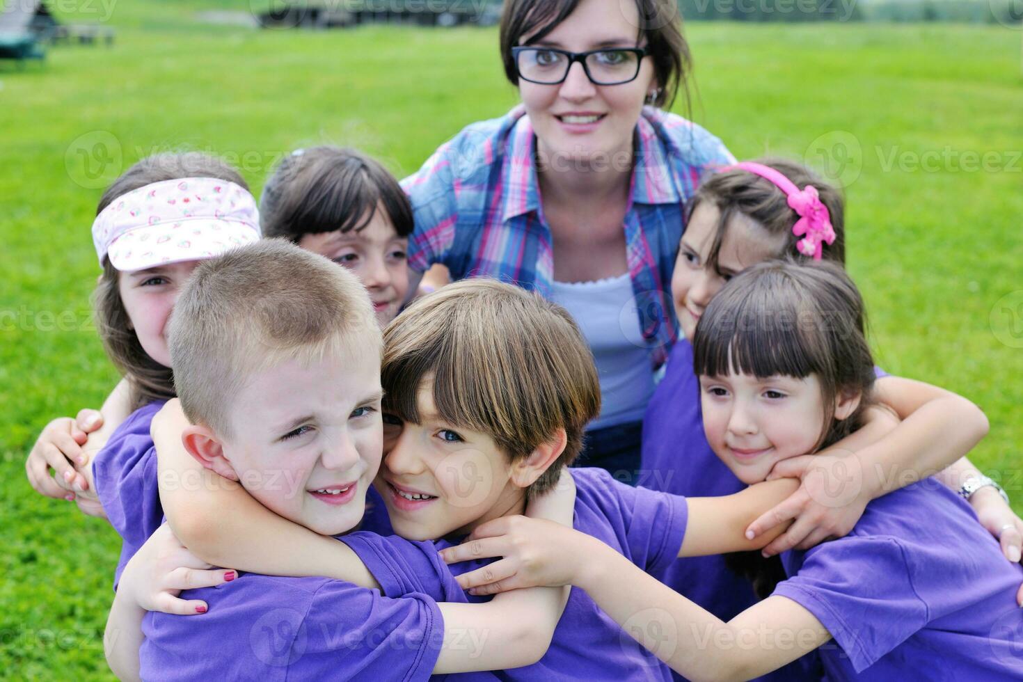 happy kids group with teacher in nature photo