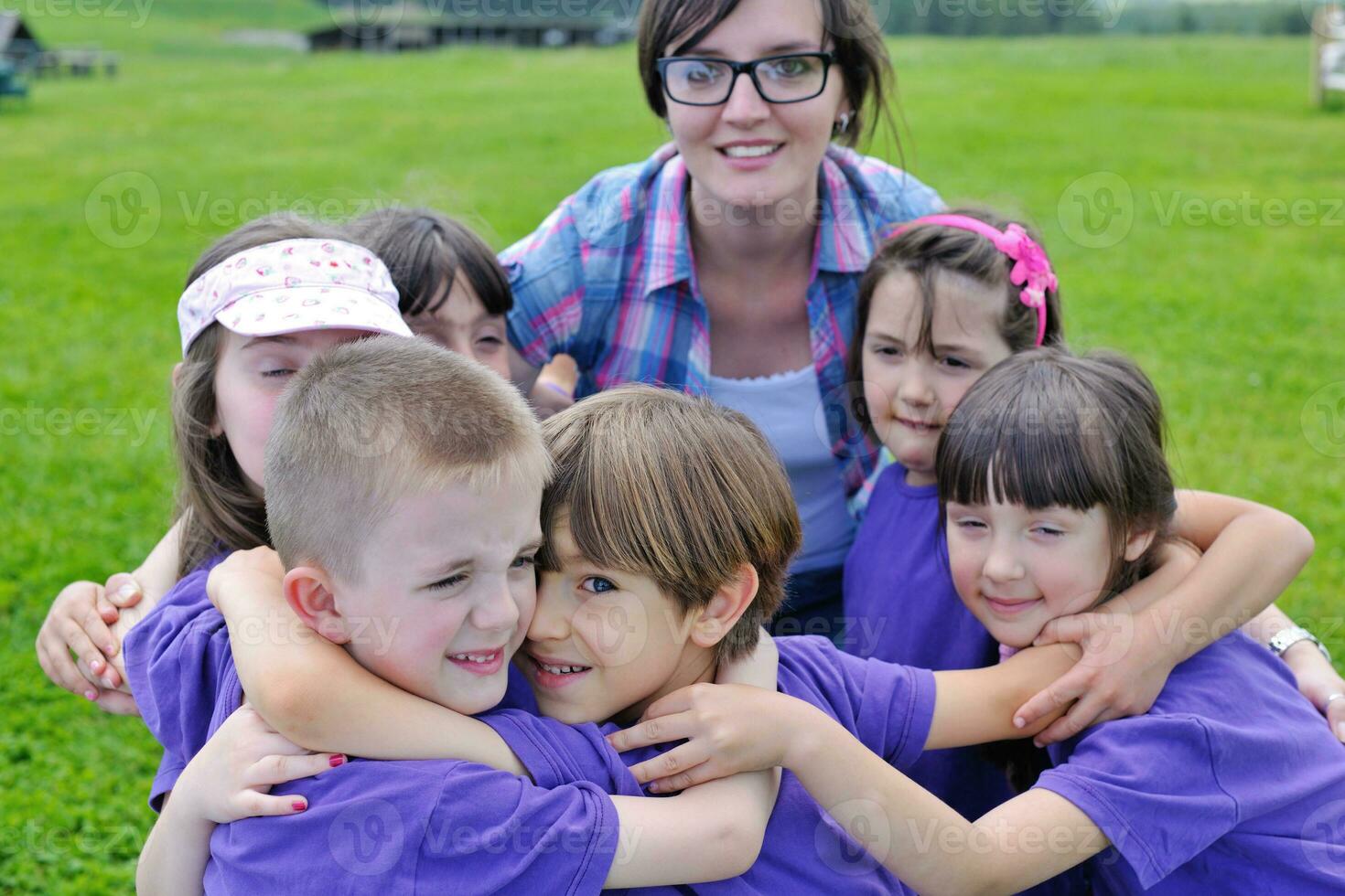 happy kids group with teacher in nature photo