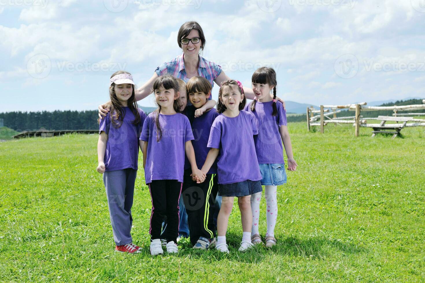 happy kids group with teacher in nature photo