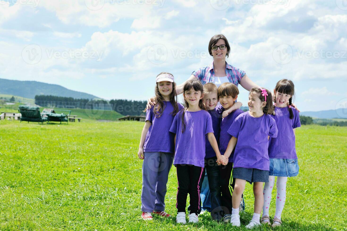 happy kids group with teacher in nature photo