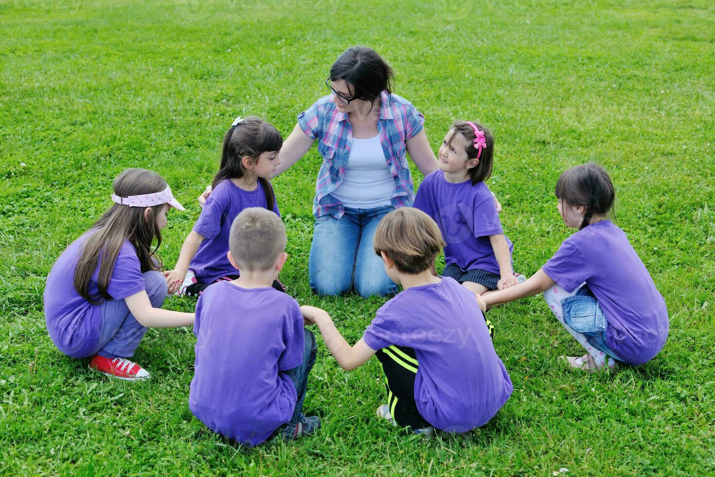 happy kids group with teacher in nature photo