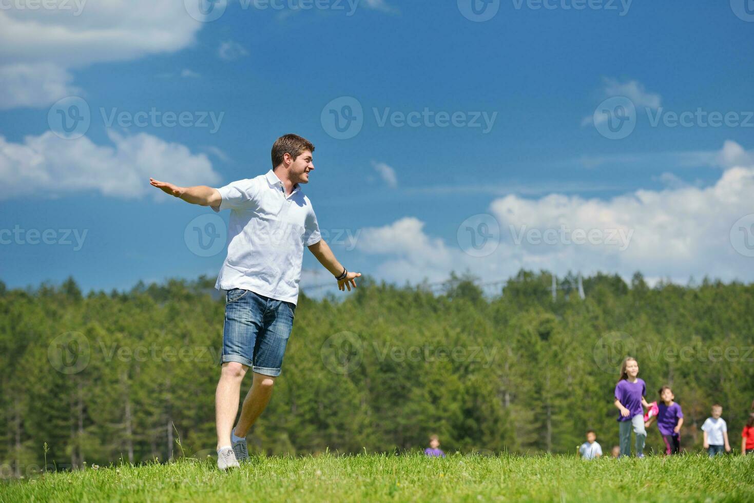 happy kids group with teacher in nature photo