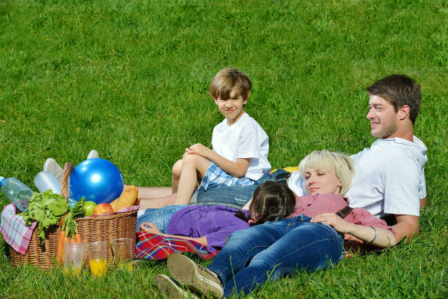 Happy family playing together in a picnic outdoors photo