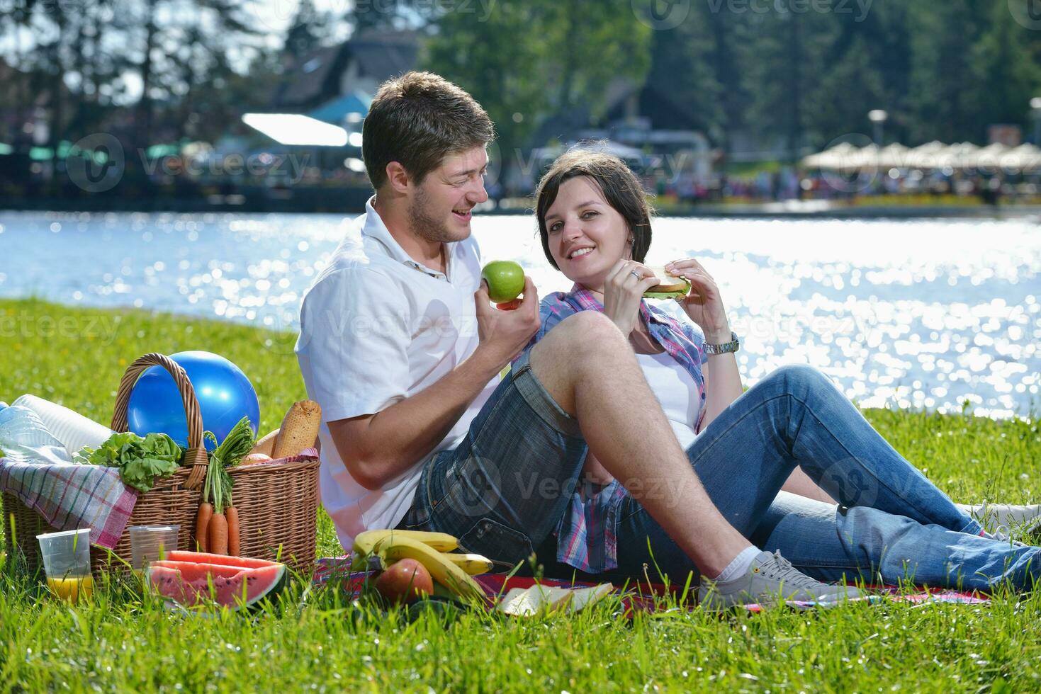 happy young couple having a picnic outdoor photo