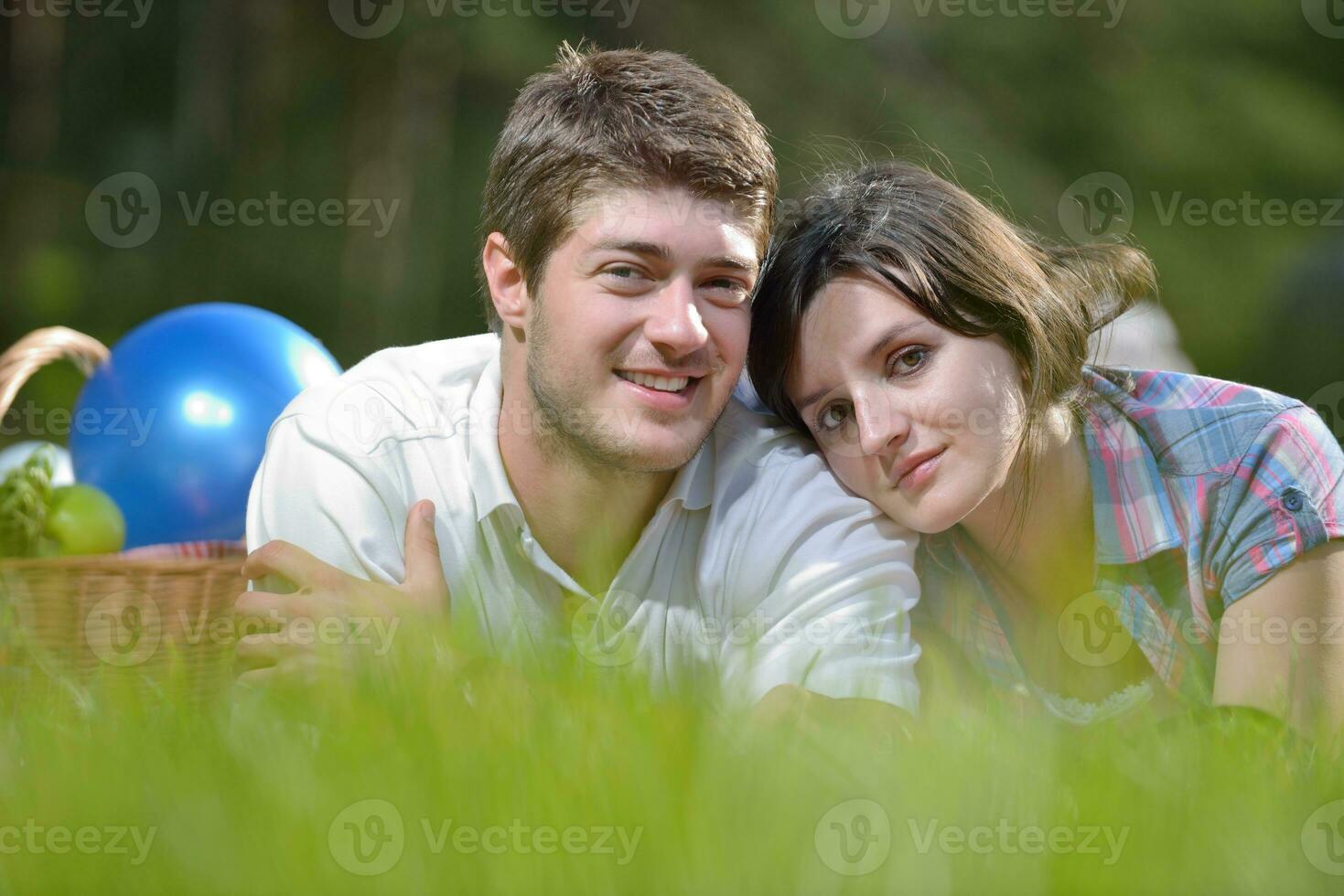 happy young couple having a picnic outdoor photo