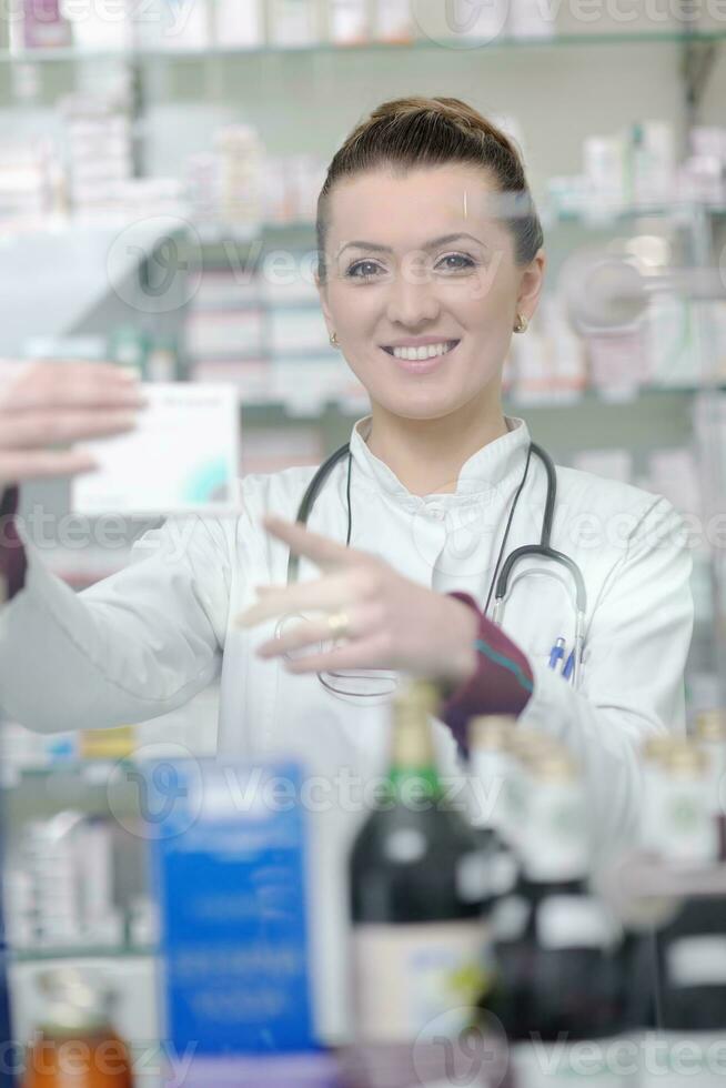 pharmacist chemist woman standing in pharmacy drugstore photo