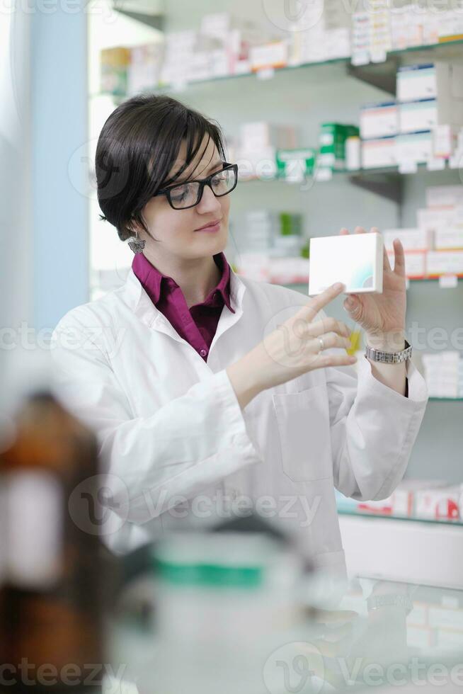 pharmacist chemist woman standing in pharmacy drugstore photo