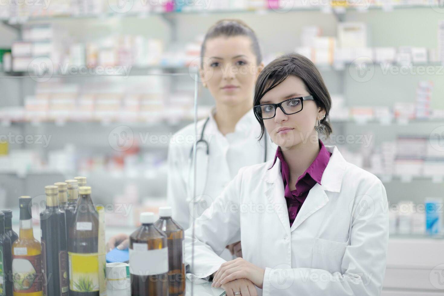 team of pharmacist chemist woman  in pharmacy drugstore photo