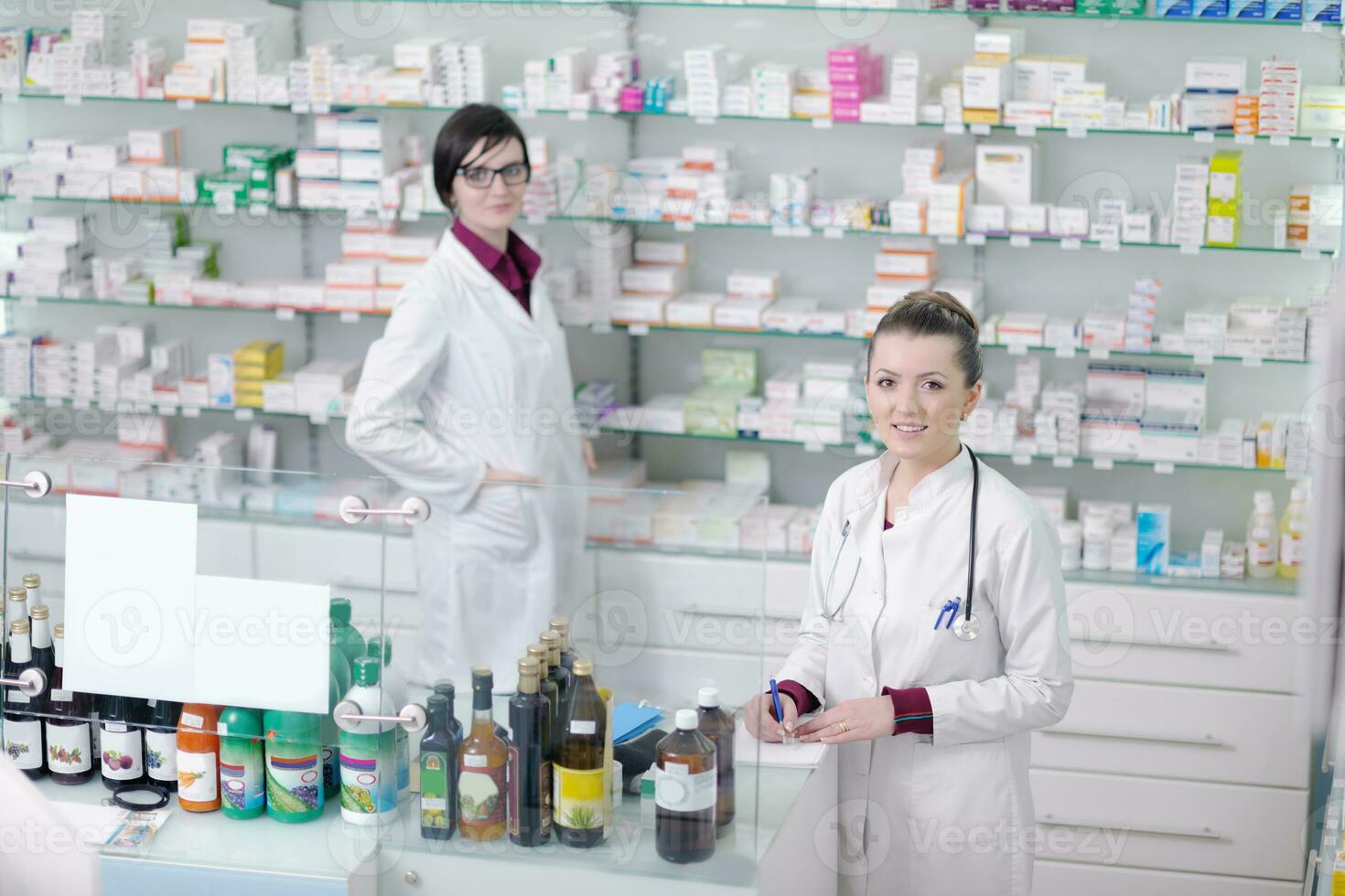 team of pharmacist chemist woman  in pharmacy drugstore photo