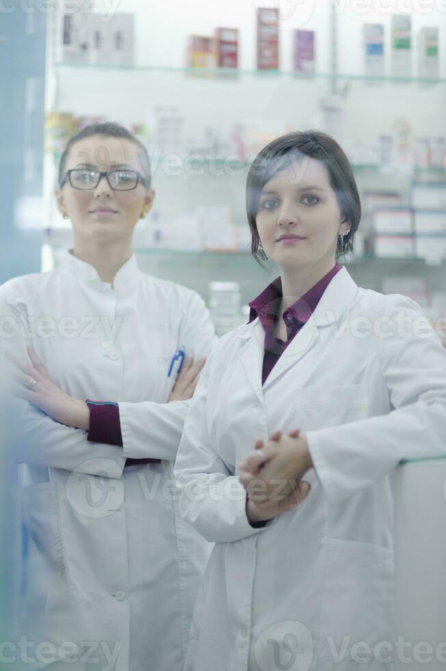 team of pharmacist chemist woman  in pharmacy drugstore photo