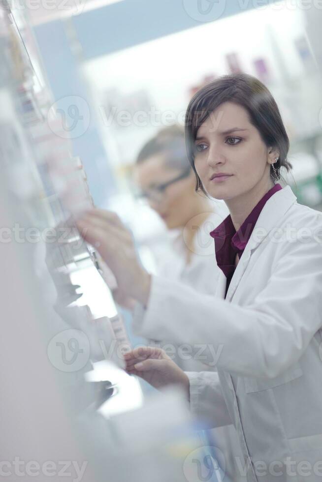 pharmacist chemist woman standing in pharmacy drugstore photo