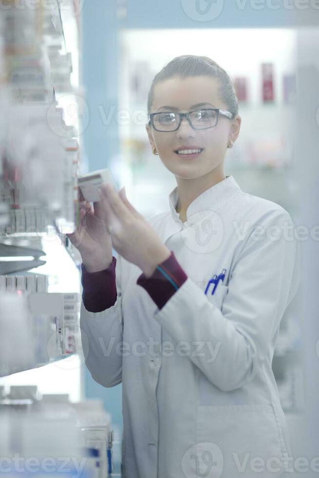 pharmacist chemist woman standing in pharmacy drugstore photo