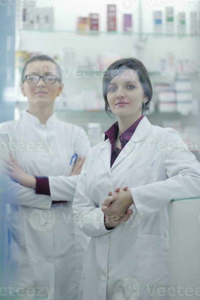 team of pharmacist chemist woman  in pharmacy drugstore photo