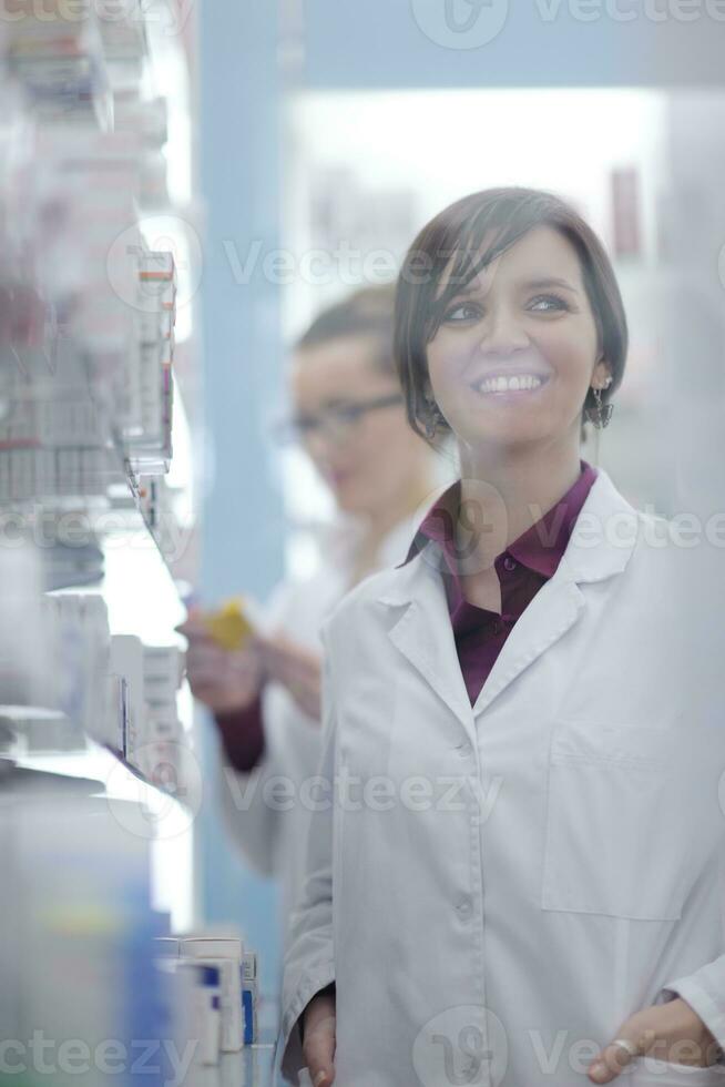 pharmacist chemist woman standing in pharmacy drugstore photo