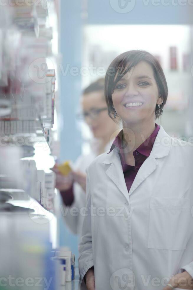 team of pharmacist chemist woman  in pharmacy drugstore photo