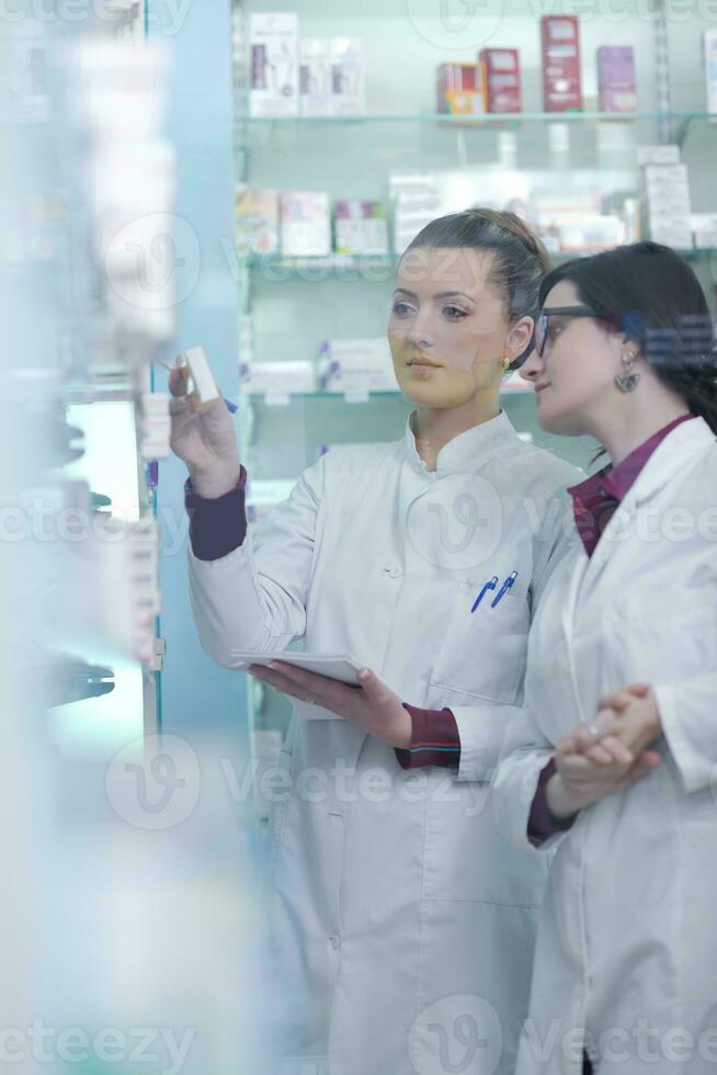 team of pharmacist chemist woman  in pharmacy drugstore photo