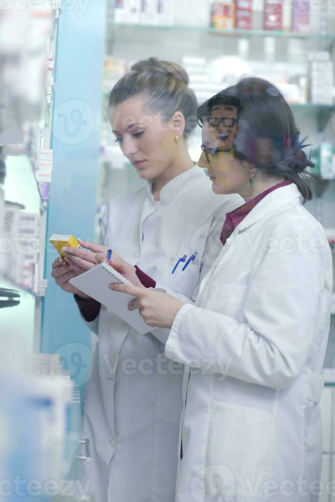 team of pharmacist chemist woman  in pharmacy drugstore photo