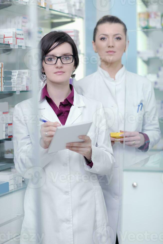 team of pharmacist chemist woman  in pharmacy drugstore photo