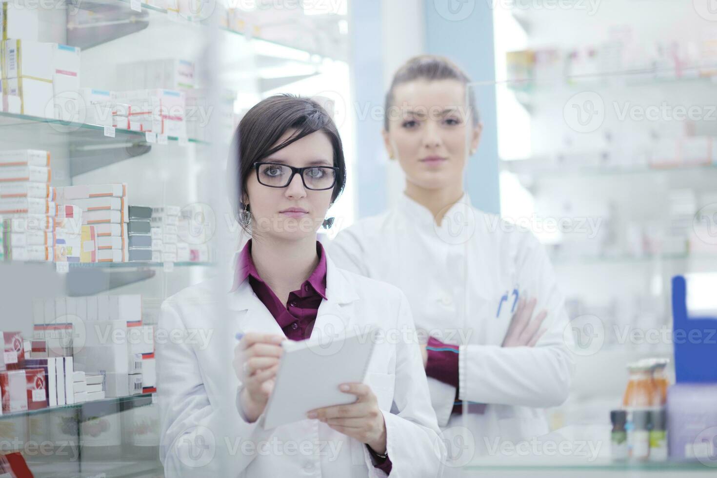 team of pharmacist chemist woman  in pharmacy drugstore photo