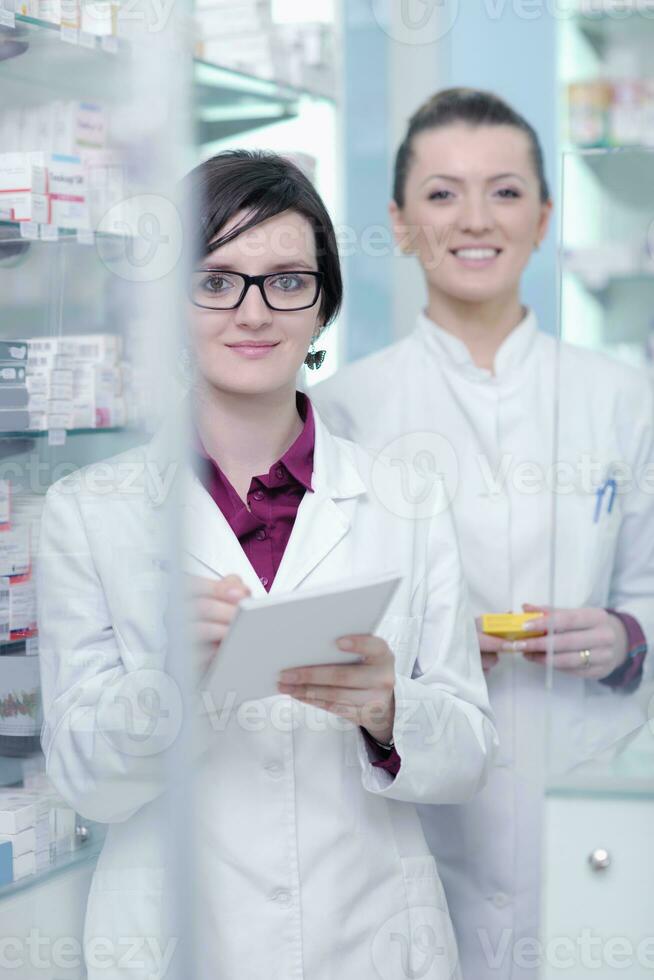 team of pharmacist chemist woman  in pharmacy drugstore photo