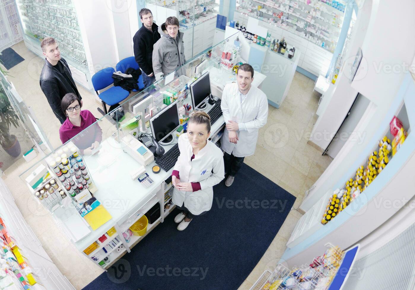 pharmacist suggesting medical drug to buyer in pharmacy drugstore photo