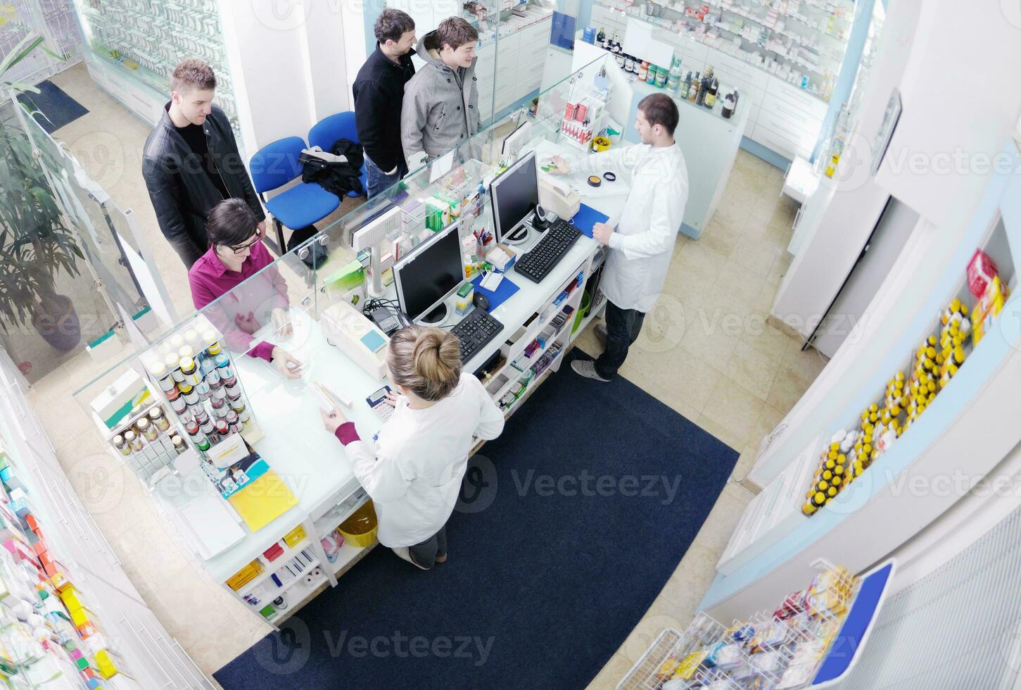 pharmacist suggesting medical drug to buyer in pharmacy drugstore photo