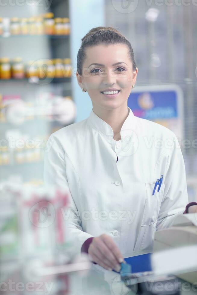 pharmacist chemist woman standing in pharmacy drugstore photo