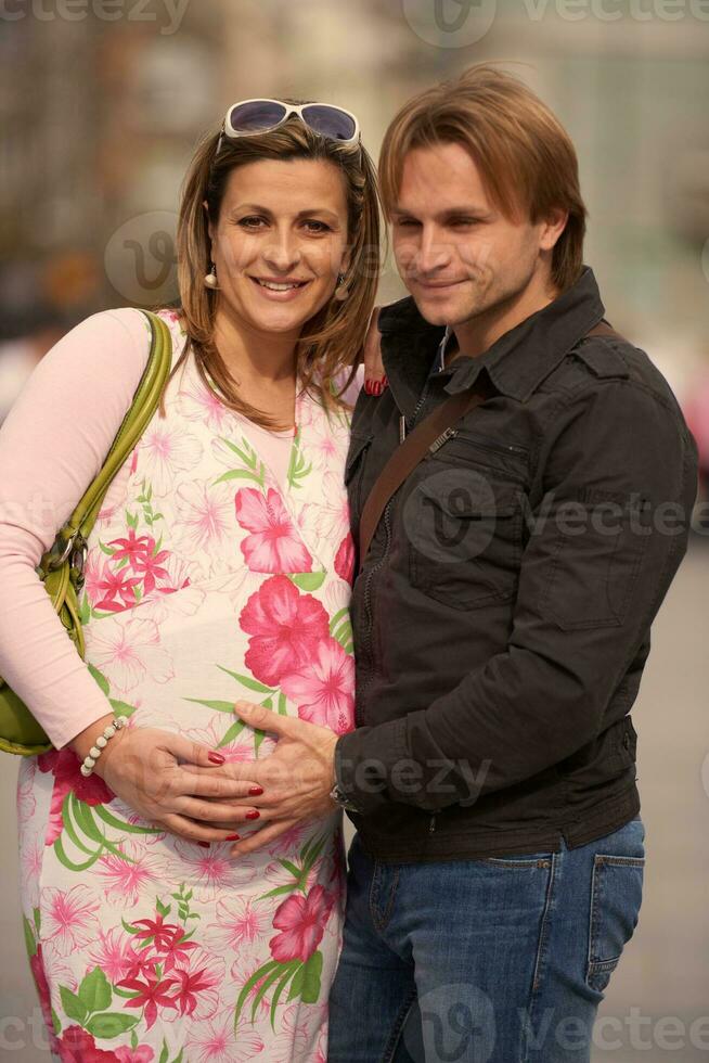 young pregnant couple have fun and relax photo
