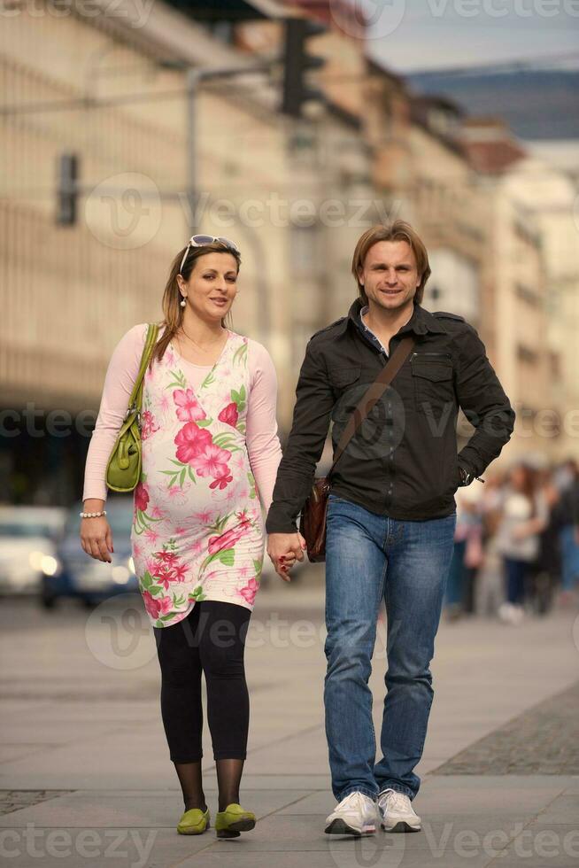 young pregnant couple have fun and relax photo