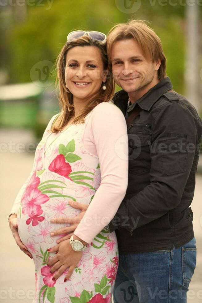 young pregnant couple have fun and relax photo