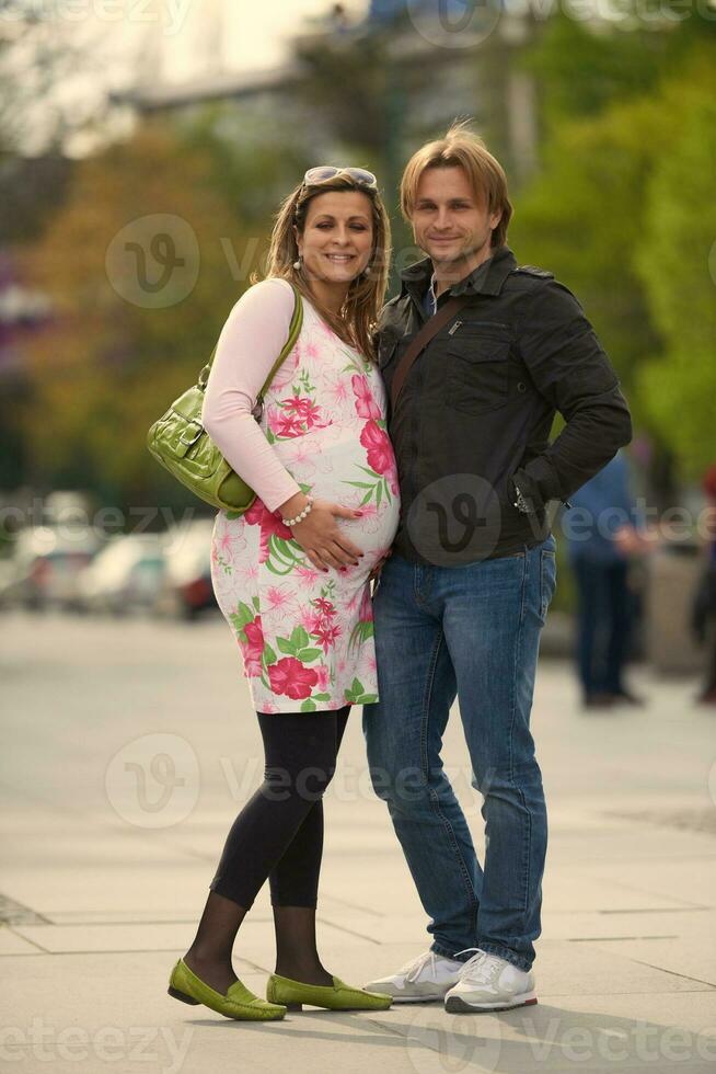 young pregnant couple have fun and relax photo