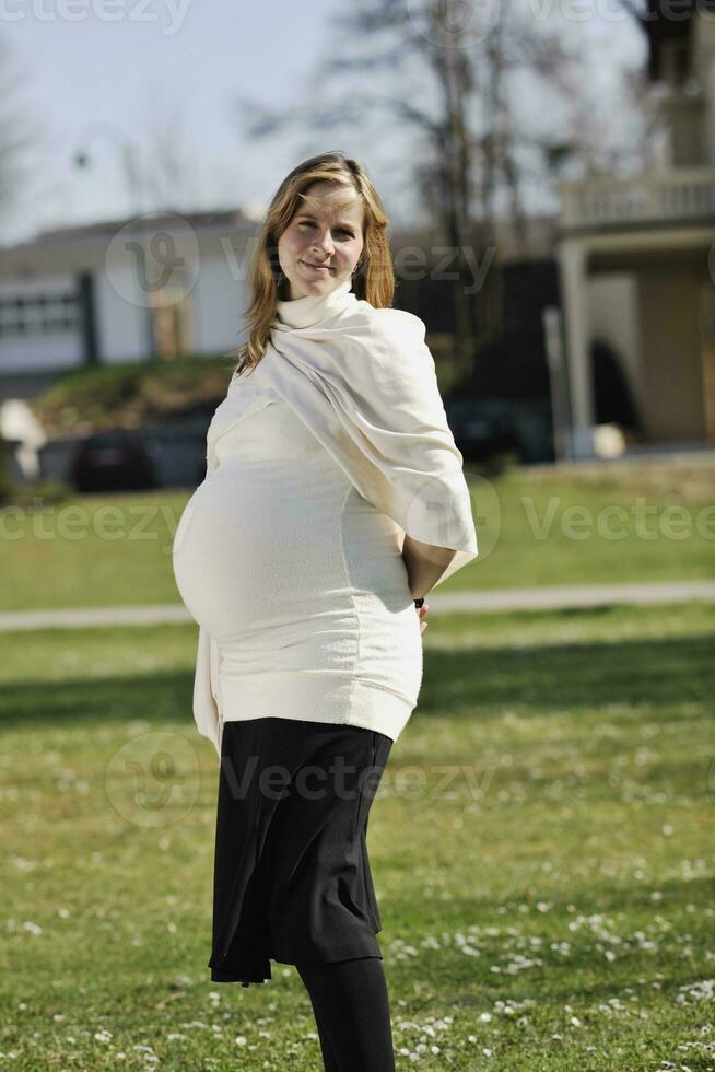 happy young pregnant woman outdoor photo