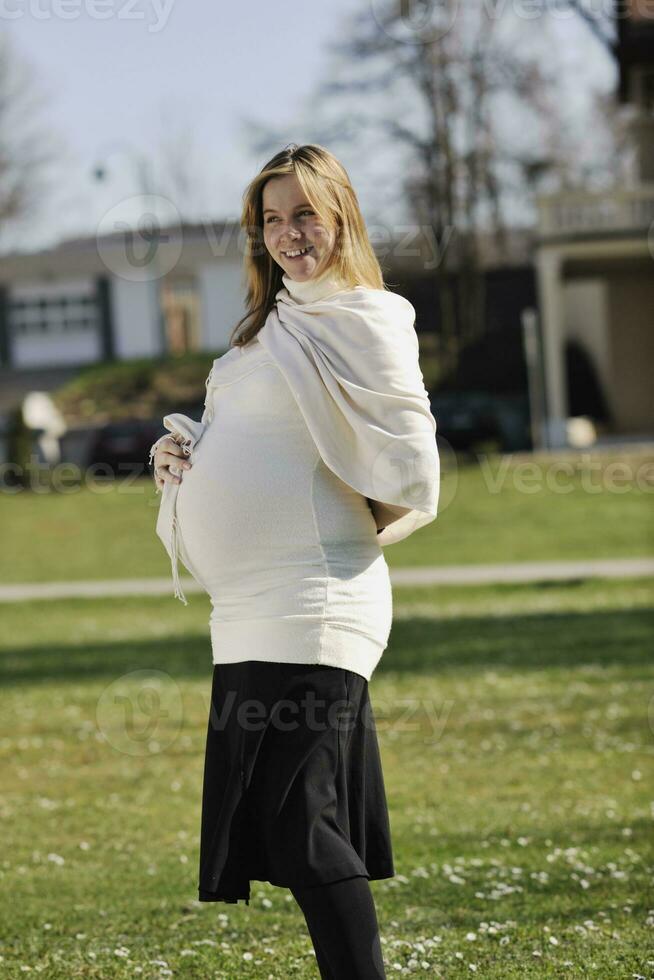 happy young pregnant woman outdoor photo