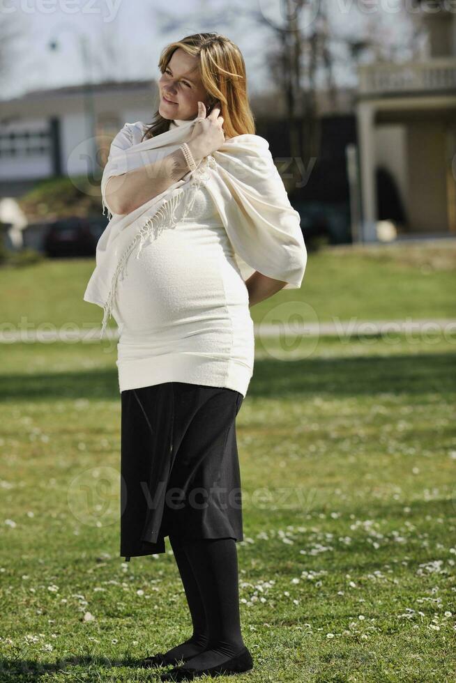 happy young pregnant woman outdoor photo