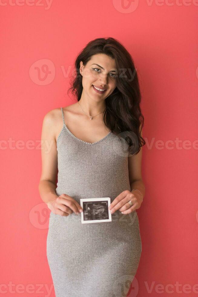 happy pregnant woman showing ultrasound picture photo
