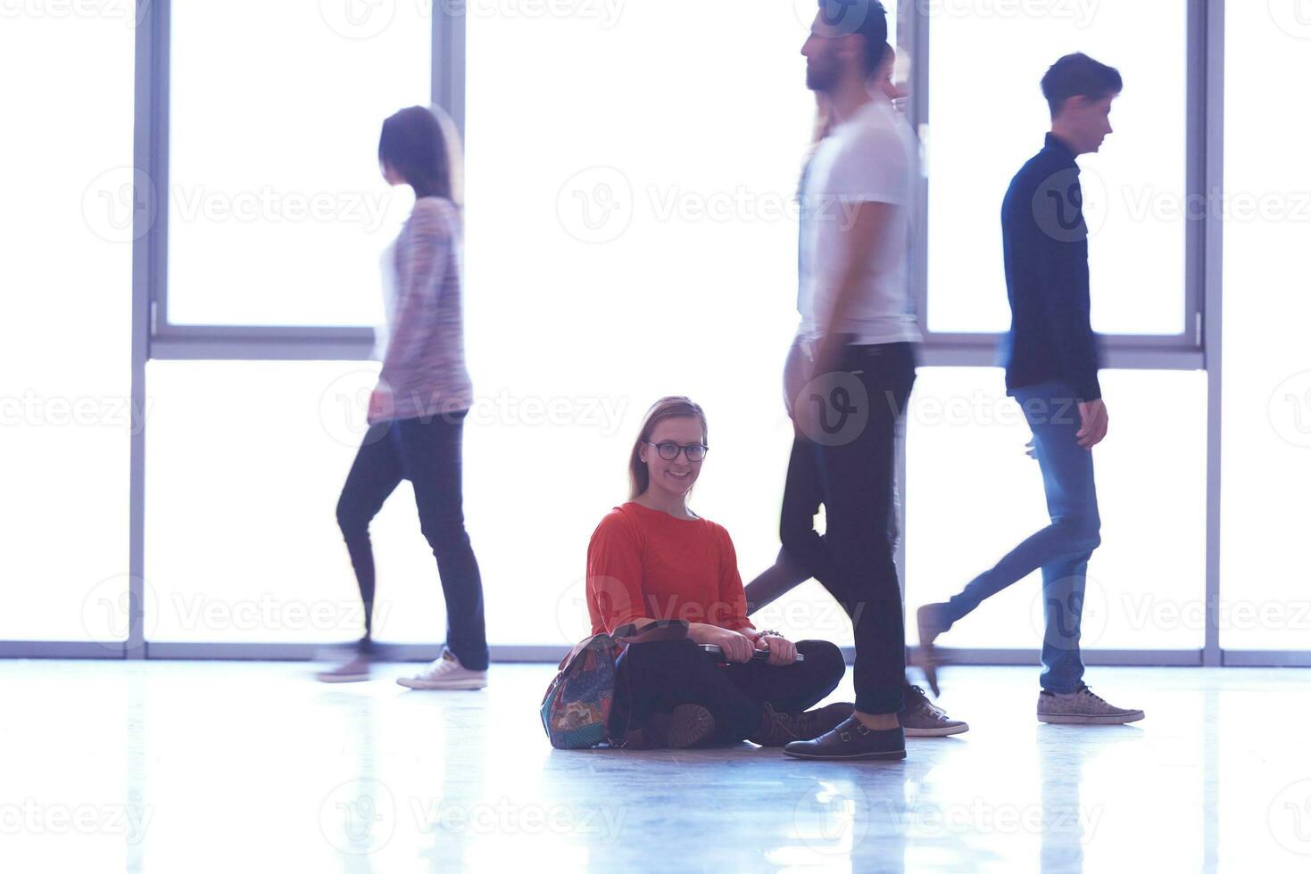 student girl standing with laptop, people group passing by photo