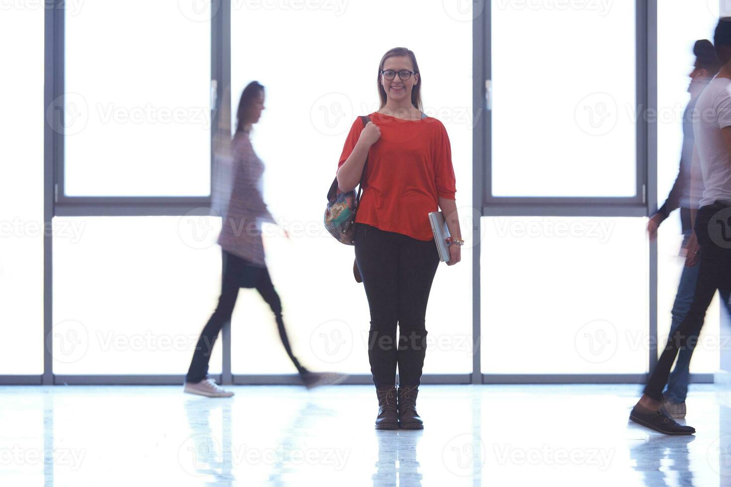 student girl standing with laptop, people group passing by photo