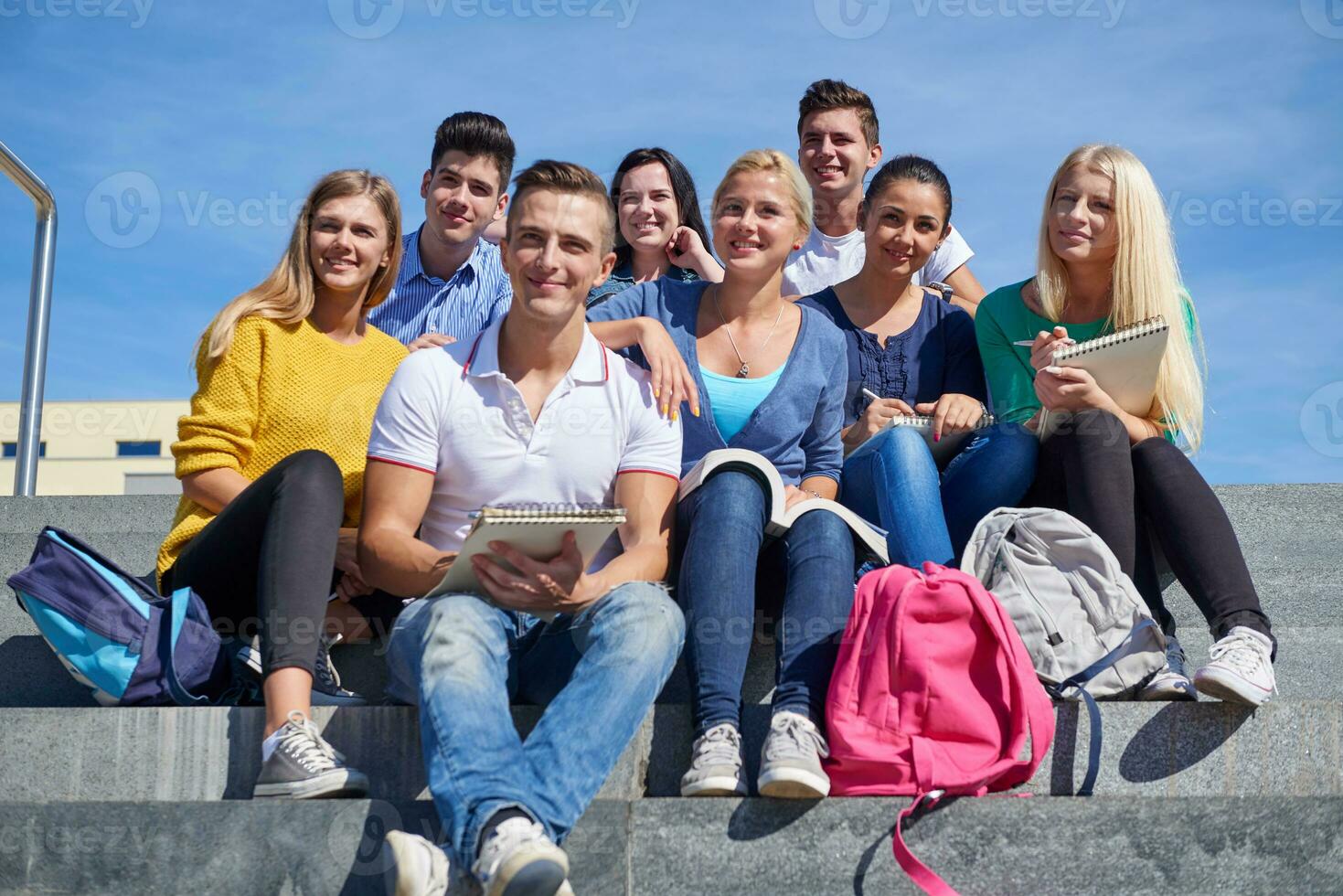 students outside sitting on steps photo