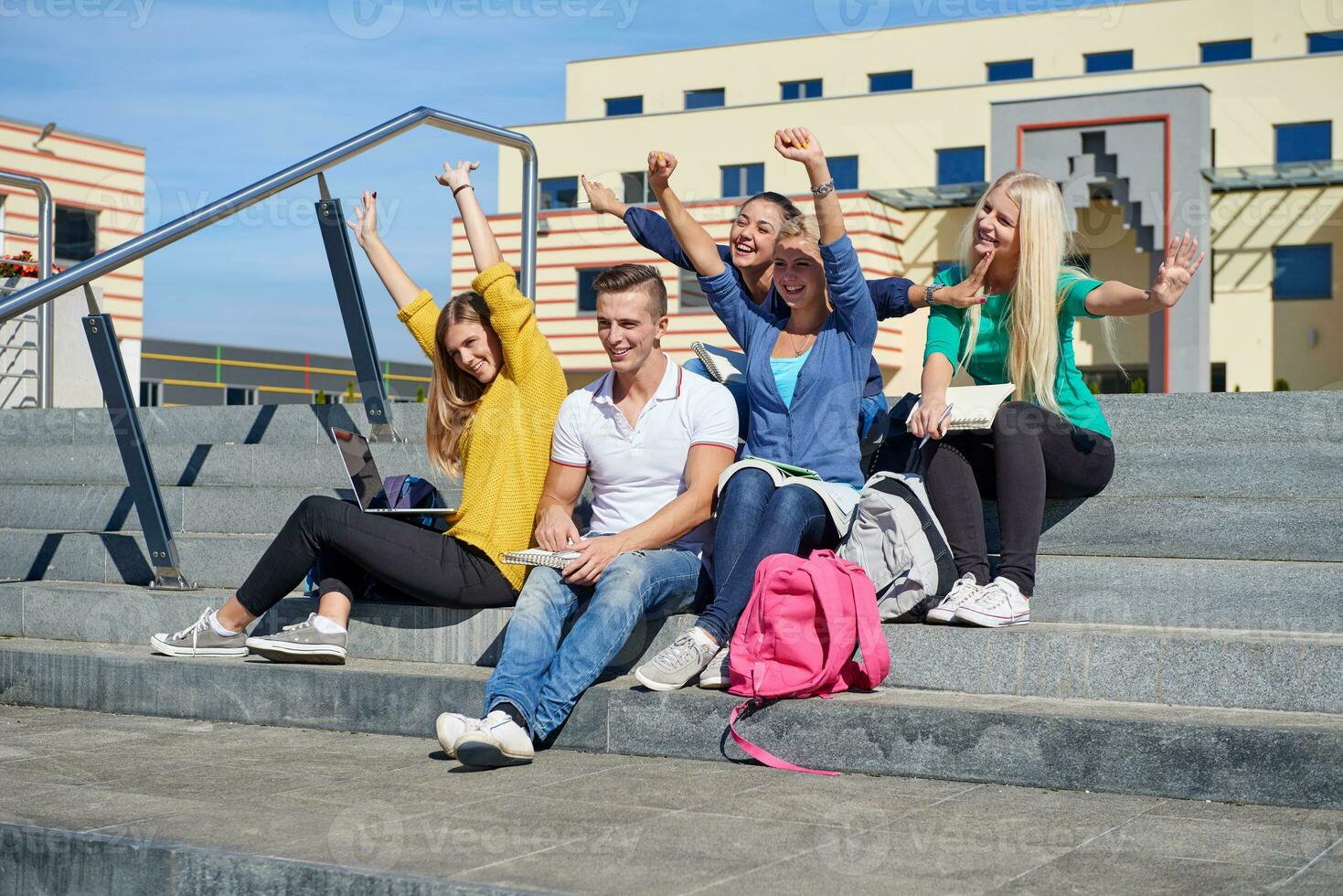 students outside sitting on steps photo