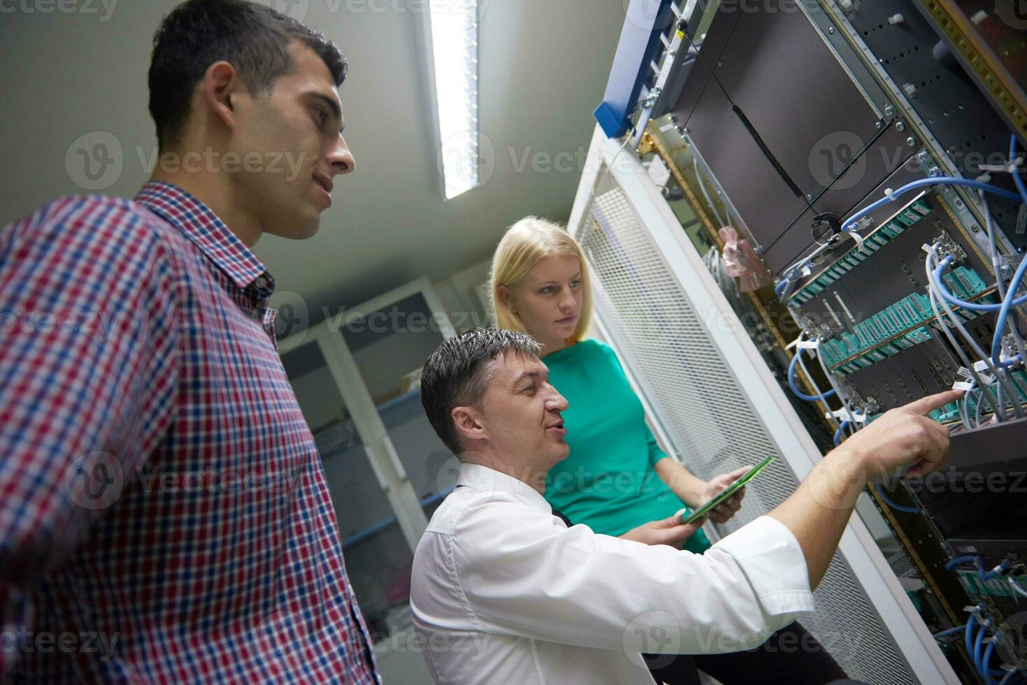 network engeneers working in network server room photo