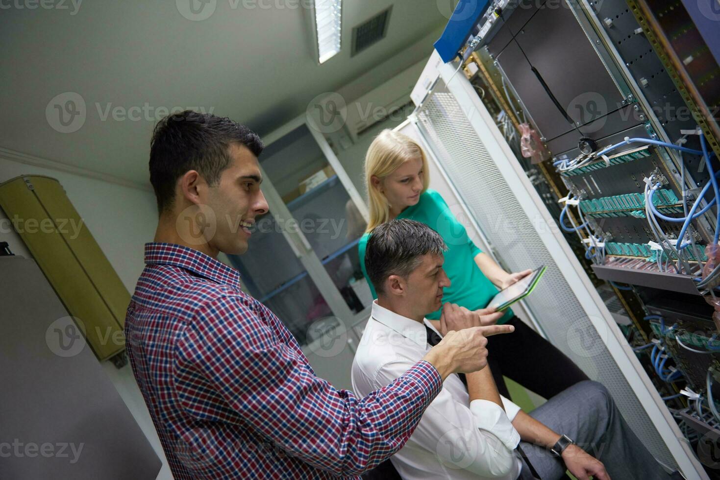 network engeneers working in network server room photo