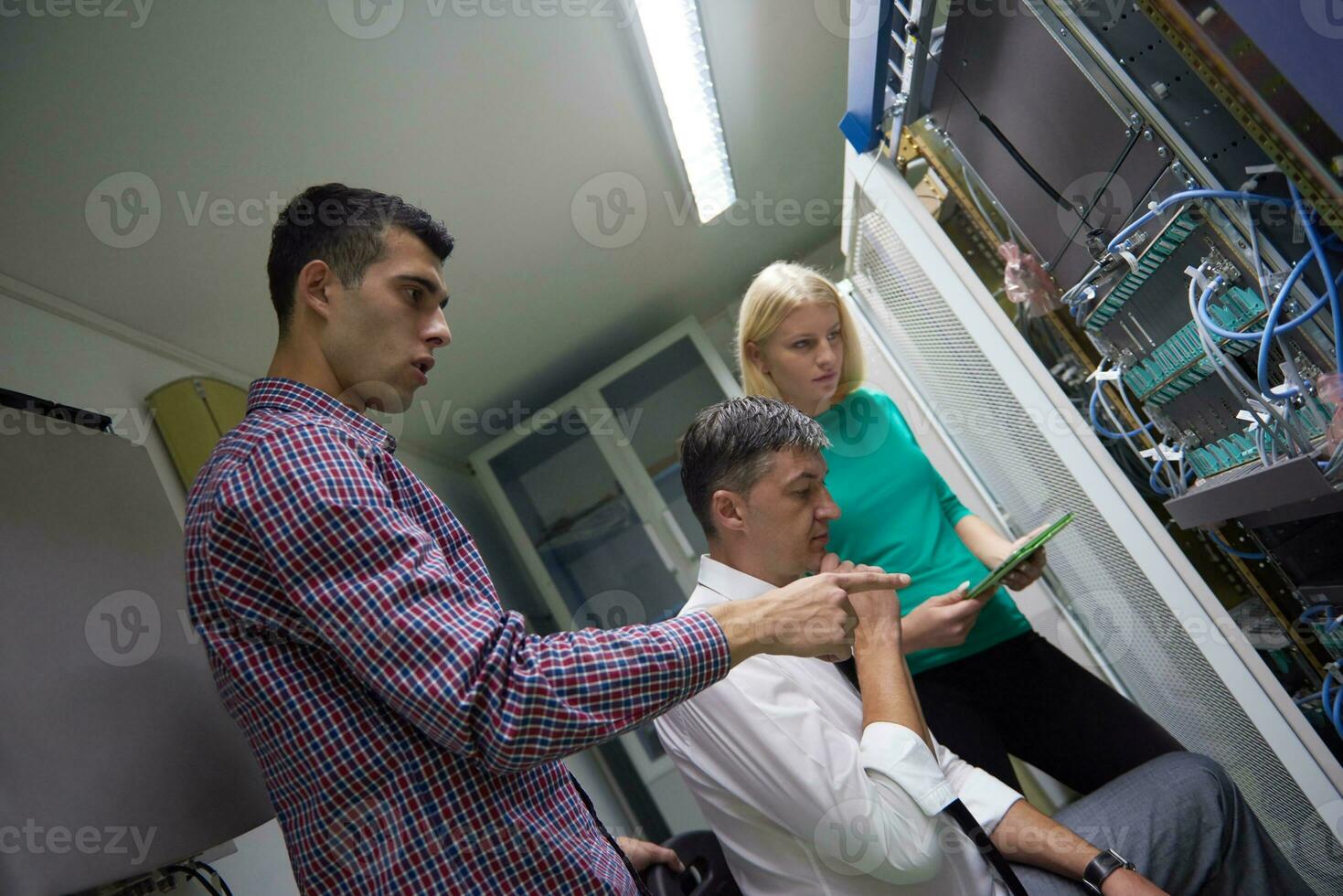network engeneers working in network server room photo