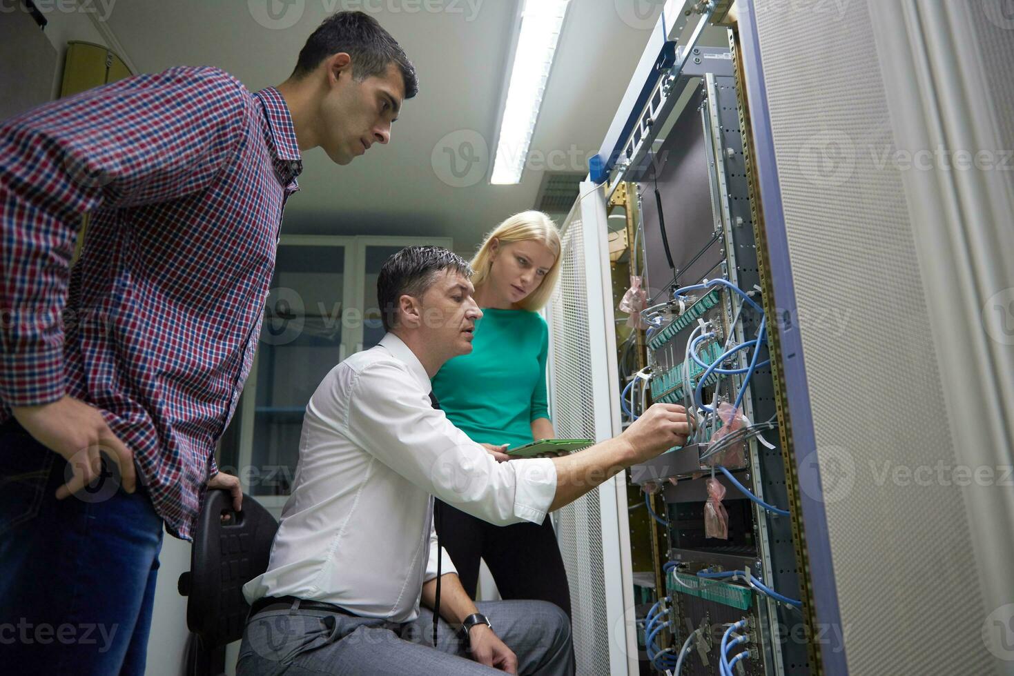 network engeneers working in network server room photo