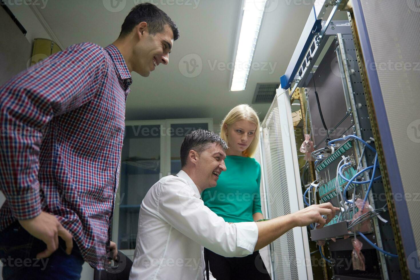 network engeneers working in network server room photo