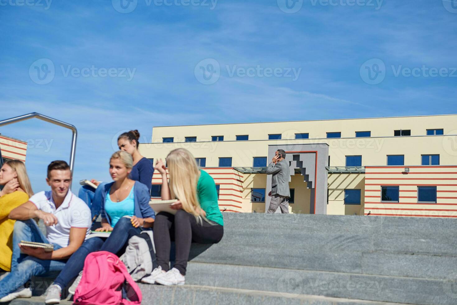 students outside sitting on steps photo